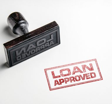 a rubber stamp with the words loan approved on it.